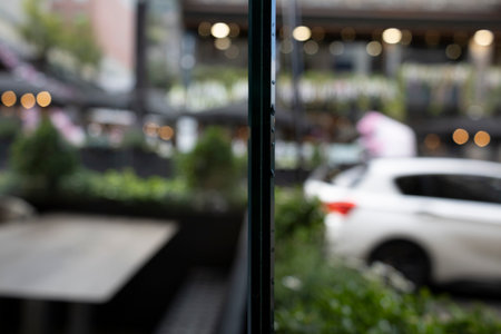 edge of a thick glass with the street blurred background and a car passingの写真素材
