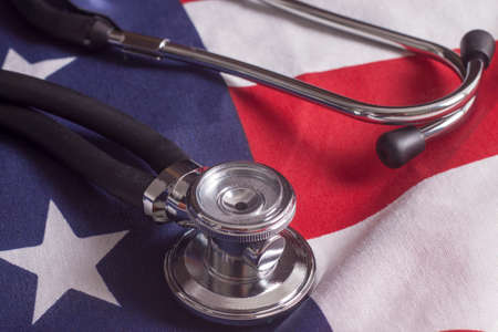 Stethoscope and pen resting on a sheet of medical insurance recordsの写真素材