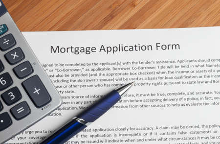 A house key sitting on mortgage application.の写真素材