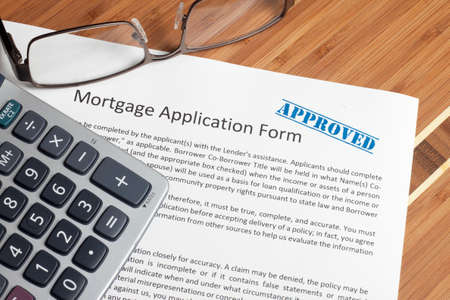 A house key sitting on mortgage application.の写真素材