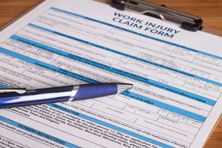 Claim form for a work injury on a desk topの写真素材