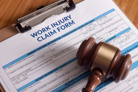 Claim form for a work injury on a desk topの写真素材