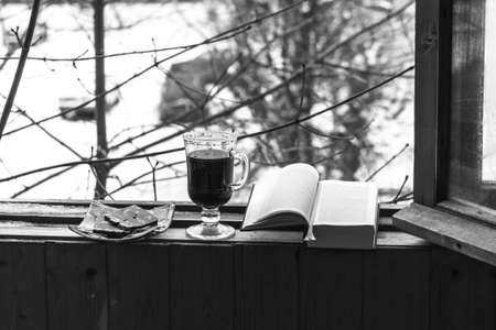 Still life with coffee and sweets, Smoking pipe and book, for a comfortable stay on the balconyの写真素材