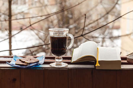 Still life with coffee and sweets, Smoking pipe and book, for a comfortable stay on the balconyの写真素材