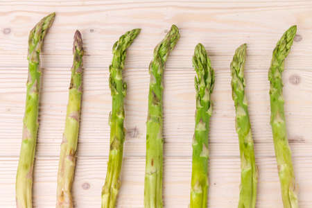 Fresh green asparagus shoots pattern, top view. Isolated over white. Food background asparagus flat lay patternの写真素材