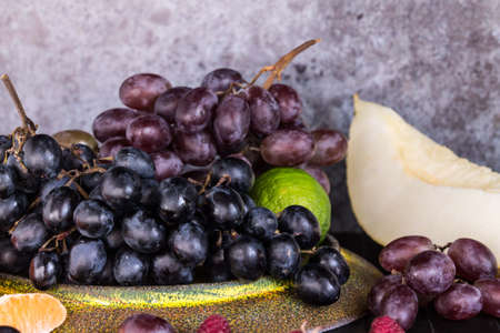 Raw Organic Fruit Platter with Berries Melons and Grapesの写真素材