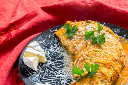 Omelet and green salad on ceramic plate.Stone background Selective focus.