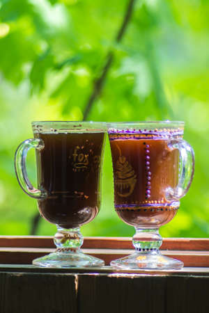 Two glass of Irish coffee on beautiful green natural background.の写真素材