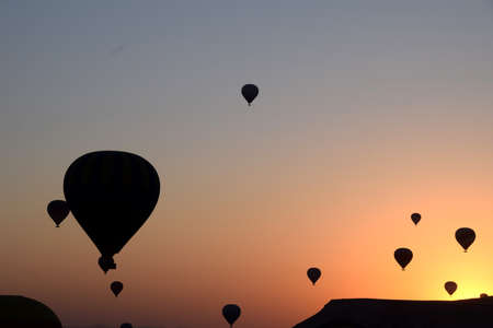 Balloon flying over Cappadocia, Turkey at sunriseの写真素材
