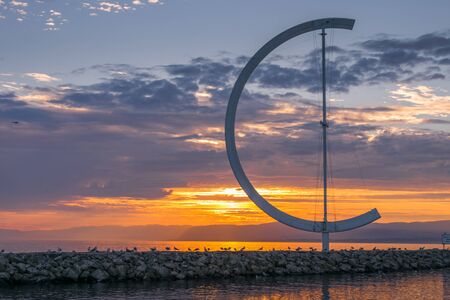 Sunset in Lausanne harbour around the district of Ouchy with 'Whirligig' Ouchy harbour front. Travel concept.の写真素材
