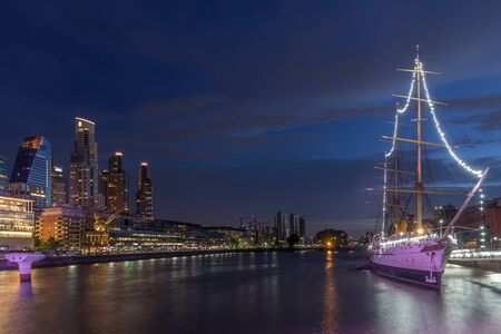 Puerto Madero at night, the buildings and the ship in Buenos Aires with the reflection of the lights in the waterの写真素材