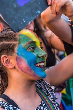 Madrid, Spain - July 06, 2019: in Madrid, Gay pride day celebrations. A young woman with a rainbow flag on her faceのeditorial素材