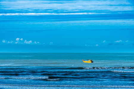 View of a boat sailing on the sea near the coast. Navigation and travel concept.の写真素材