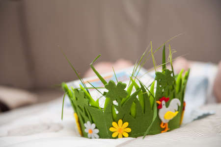 Bright colorful basket of felt with chicken and flowers on a grey background. Handmade from felt....