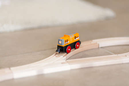 Wooden toy train on a track with blurred background