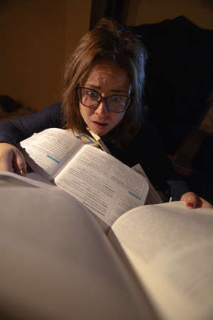 stressed woman studying in a library for final exams