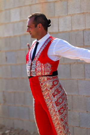 a Spanish bullfighter with a red dress in a bullfight in summerの写真素材