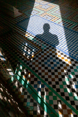 silhouette of a man sitting on the stairs of a mosque in Marrakechの写真素材