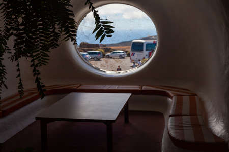 View through the window with a view of the sea and mountains.