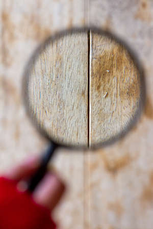 magnifying glass on a wooden background, the concept of search and findの写真素材