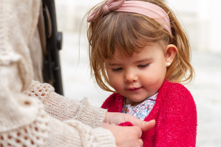 Close-up portrait of a cute little girl looking at her motherの写真素材