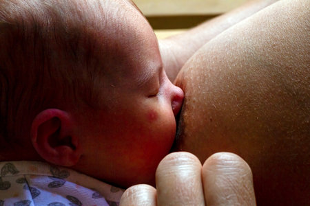Newborn Baby Attempting to Latch for Breastfeeding with Mothe