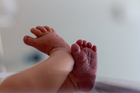 Tiny Newborn Feet in Hospital Settingの写真素材