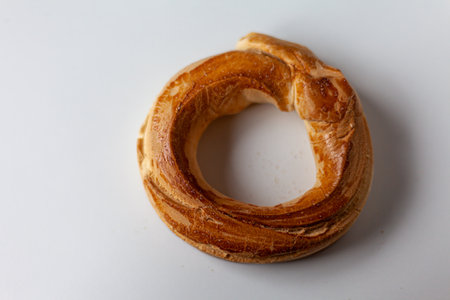 Spanish traditional pastry: handcrafted anise donut with a golden crust, isolated for a clean and...