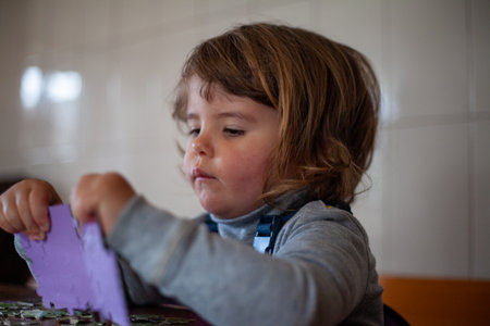 Preschooler enjoying a puzzle game in a cozy home setting
