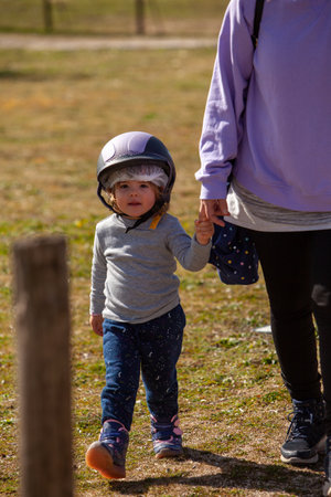 Young Girl Preparing to Ride with Her Helmet.