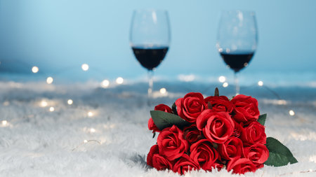 Red roses and glass of wine and red roses on white carpetの写真素材