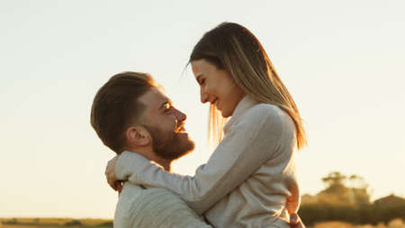 Boy and Girl couple hug and walk together in the natural parkの写真素材