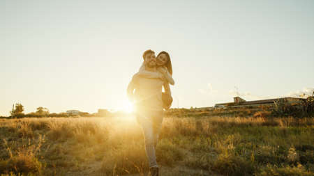 Boy and Girl couple hug and walk together in the natural parkの写真素材