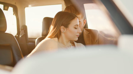 Happy boy and girl in the off road car during valentines dayの写真素材