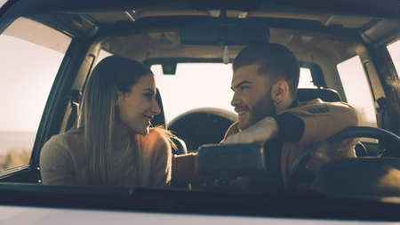 Happy boy and girl in the off road car during valentines dayの写真素材