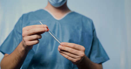 Young nurse prepares tube tube for covid swab test