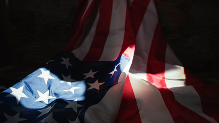 USA flag under lit by a window light