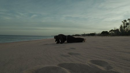 Monk Does Workout Push Ups Sport Training On The Beachの写真素材