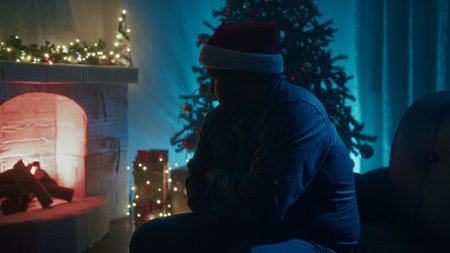 Cold Man On Sofa Warms Up By The Fireplace On Christmas Eve Night Roomの写真素材