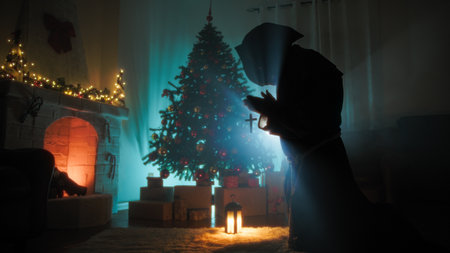 Religious Monk Man Prays Silhouette Kneeling In Front Of Christmas Tree At Nightの写真素材
