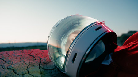 Tired Astronaut Sleeps On Mountain Wasteland Exhausted In New Lifeless Planetの写真素材