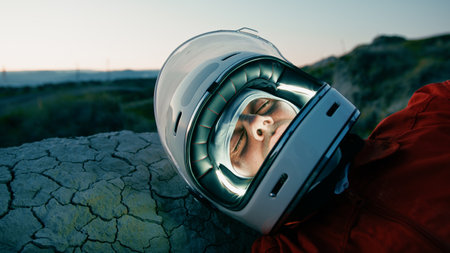 Astronaut With Helmet Sleeps At Night In New Uninhabited Planetの写真素材