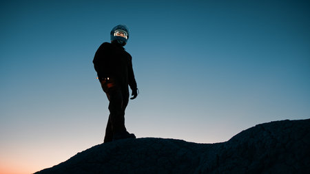 Silhouette Of An Astronaut Explores The Mountain Of An Abandoned Hostile Planet