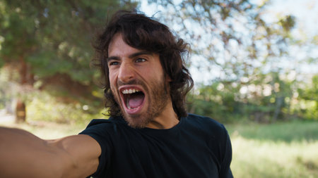 Angry Long Hair Man Arguing Furiously in the Park Saying No