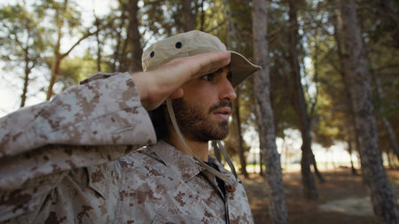 Faithful Soldier Salutes Several Times As A Sign Of Respect Under Tree In Natureの写真素材