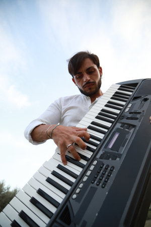 Keyboard Player Standing In Nature With Olive Trees In Calabriaの写真素材
