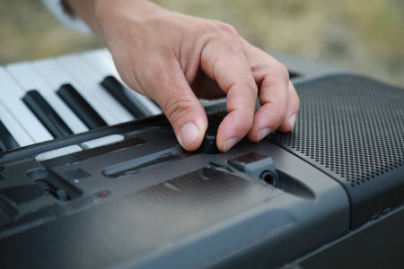 Hands Of A Boy Play The Musical Keyboard Crossing In Rhythm In The Countrysideの写真素材
