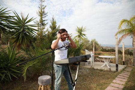 Musician Arranges His Keyboard For The Evening Performance In A Parkの写真素材