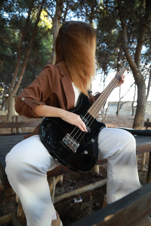 Girl Plays The Bass Instrument In The Countryside In Summer