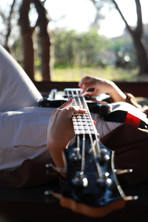 Girl Plays Bass Musical Instrument Lying On Tableの写真素材